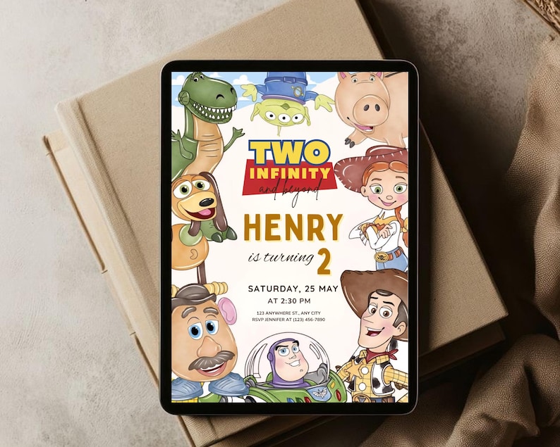 May include: A digital invitation on a tablet featuring cartoon characters from a popular animated film. The invitation reads "Two Infinity and Beyond" and includes the name "Henry" and the number "2". The date and time are also included.