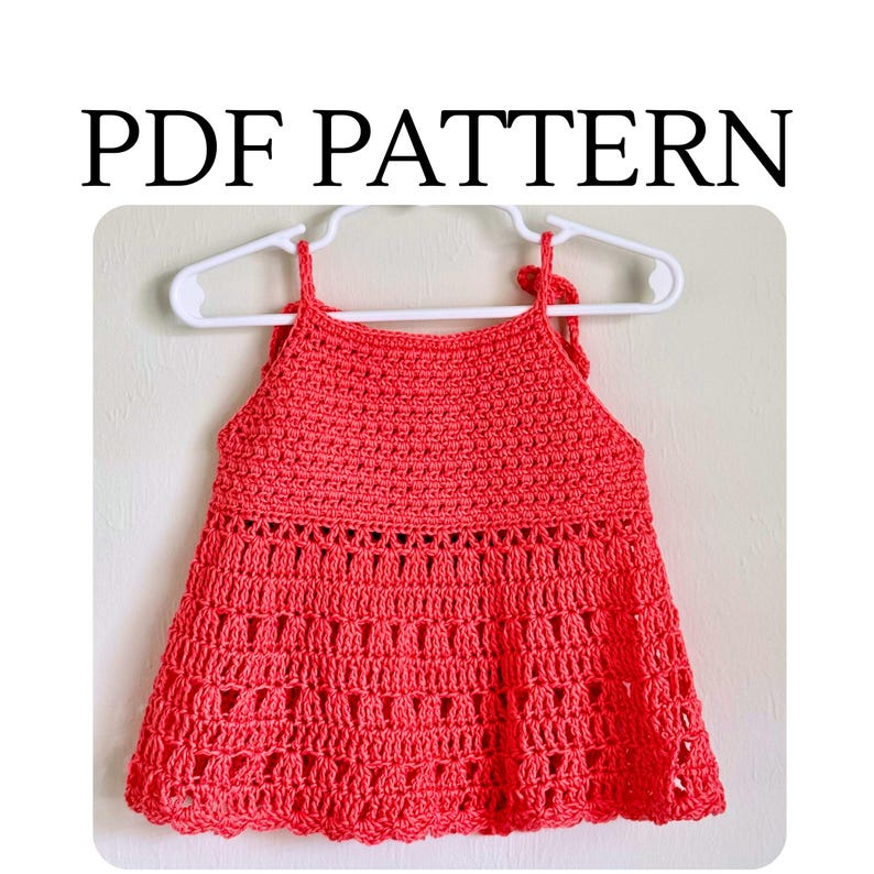 May include: A coral-colored crochet top featuring a solid stitch bodice and a decorative openwork skirt section. The garment is displayed on a white plastic hanger and includes the text PDF PATTERN printed in black above the image.