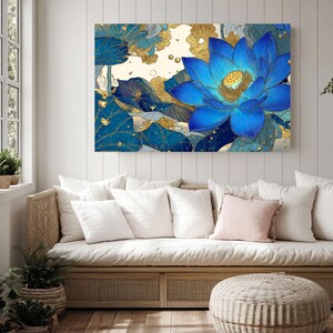 May include: A large canvas art print featuring a vibrant blue lotus flower with gold accents. The artwork is set against a backdrop of blue and gold foliage, creating a striking contrast. The floral art piece is displayed above a light-colored sofa with white pillows.