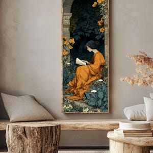 May include: A vertical rectangular wall art print featuring an illustration of a person with dark hair wearing a long orange dress, sitting and reading a book within a stone archway surrounded by dark green foliage and bright yellow flowers.