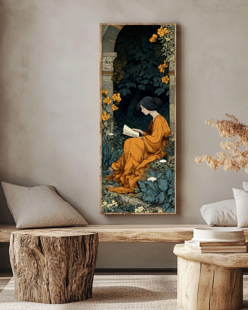 May include: A vertical rectangular wall art print featuring an illustration of a person with dark hair wearing a long orange dress, sitting and reading a book within a stone archway surrounded by dark green foliage and bright yellow flowers.