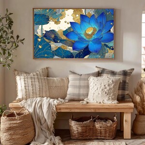 May include: A framed wall art print featuring a vibrant blue lotus flower with gold accents. The artwork is displayed above a wooden bench with decorative pillows, baskets, and a rug, creating a cozy and inviting interior design.