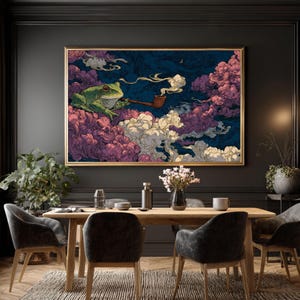 May include: A framed art print featuring a green frog smoking a pipe, set against a backdrop of purple, pink, and white clouds on a dark blue background. The artwork is in a gold frame, creating a whimsical and surreal scene. The print is displayed above a wooden dining table.