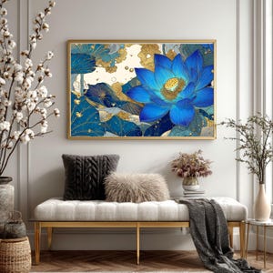 May include: A framed art print featuring a vibrant blue lotus flower with gold accents. The artwork is displayed above a bench with decorative pillows and a throw blanket. The room is decorated with neutral tones and natural elements.