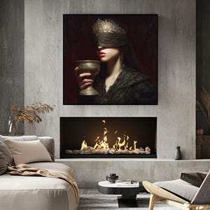 May include: A framed artwork depicts a person wearing a gold blindfold and holding a gold chalice. The artwork hangs above a fireplace with a glowing fire. The room features neutral-toned furniture and decor, creating a modern and artistic ambiance.