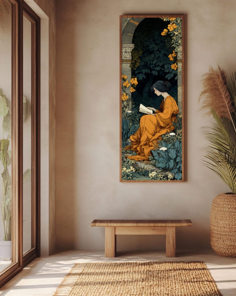 May include: A vertical rectangular wall art print featuring a person in a flowing orange robe sitting and reading a book within a dark stone archway surrounded by lush green foliage and clusters of vibrant yellow flowers in a garden setting.