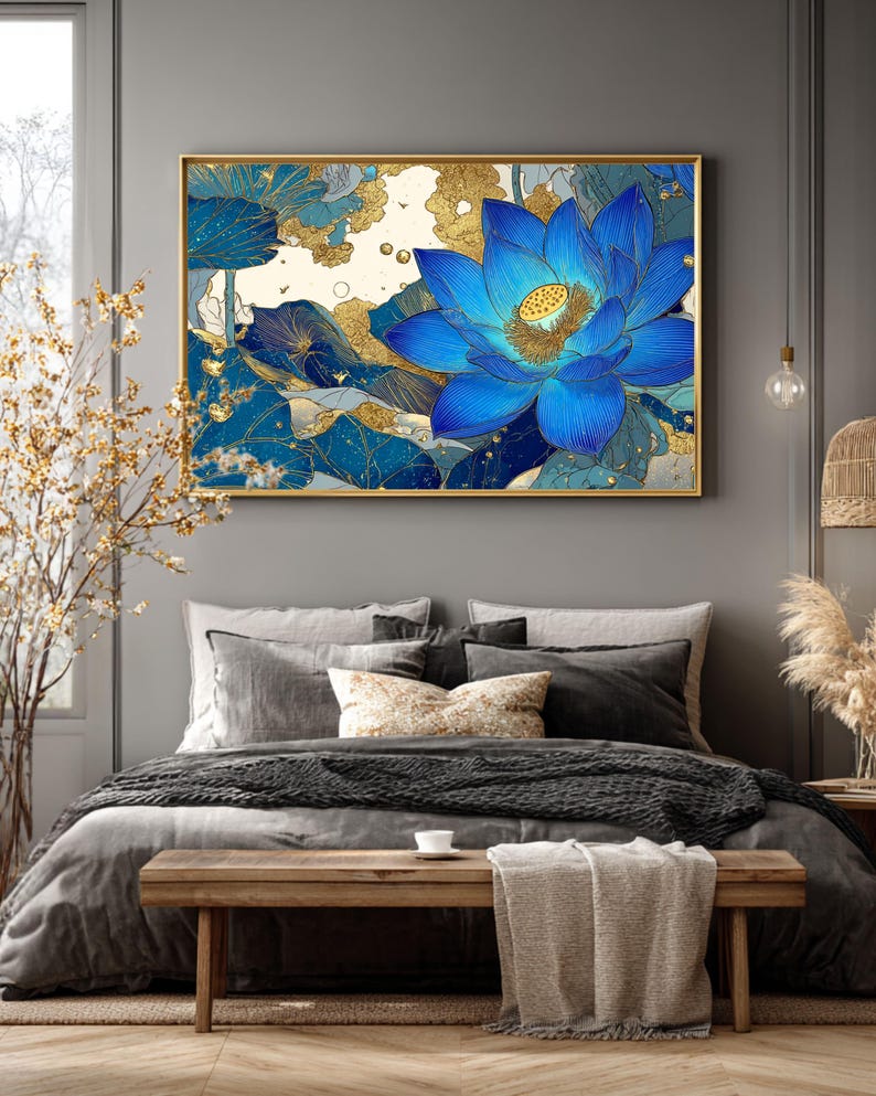 May include: A framed wall art print featuring a vibrant blue lotus flower with gold accents. The artwork showcases intricate details and a blend of blue and gold hues. The floral design is set against a neutral background, creating a striking visual contrast. The frame is gold.