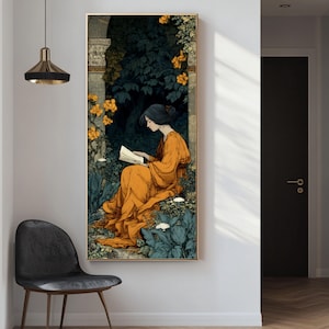 May include: A vertical rectangular wall art print featuring a person with dark hair wearing a flowing orange robe, sitting and reading an open book. The scene is set within a dark, lush garden with stone architectural elements and bright yellow flowers.