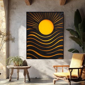 May include: A black and yellow wall art piece featuring a sun design with radiating lines and wavy lines. The sun is a bright yellow circle. The artwork is framed in black and hangs on a white wall.