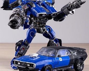 May include: A blue and black toy robot figure with a matching blue and black car. The robot has large weapons and is posed as if in action. The car has the number 13 on the side.