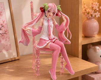 May include: A pink-haired anime character figurine with cherry hair accessories, wearing a white sleeveless top, pink tie, and pink skirt, sitting on a translucent pink chair. The figure has long flowing hair and pink thigh-high boots.