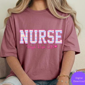 May include: A mauve-colored t-shirt with the word "NURSE" in large, block letters. The letters are filled with a pastel pattern of blue, pink, and yellow. Below the word is the text "High Risk OB" with a pink heart.