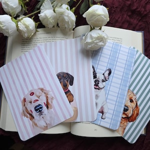 Könnte beinhalten: Vier Grußkarten zum Thema Hunde mit verschiedenen Rassen, jede mit einem einzigartigen Design. Die Karten zeigen einen Golden Retriever mit Lippenstiftküssen, einen Dackel, eine französische Bulldogge und einen Cocker Spaniel. Die Karten haben gestreifte Hintergründe.
