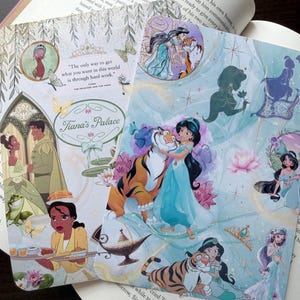 May include: Two decorative Disney Princess themed bookmarks. One features Tiana from "The Princess and the Frog" with the text "Tiana's Palace". The other features Jasmine from "Aladdin" with a tiger and other images.