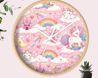 May include: A round wall clock with a light wood frame. The clock face features a pink background with a repeating pattern of unicorns, rainbows, clouds, stars, and hearts. The clock hands are white.