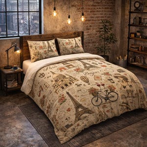 May include: Beige bedding set featuring Parisian landmarks like the Eiffel Tower and Sacré-Cœur Basilica. The design includes floral accents, bicycles, and the word "Bonjour!" in a vintage style. Includes two pillowcases.