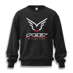 May include: Black sweatshirt with a white and red logo. The logo features a stylized wing design above the word "FELT" in white, with "bicycles" in red below. A classic crew neck sweatshirt.