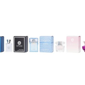 May include: A collection of miniature Versace fragrances, including bottles and boxes in various colors. The bottles have different shapes and colors, with some featuring a clear, textured design. The boxes are in shades of blue, black, pink, and purple.