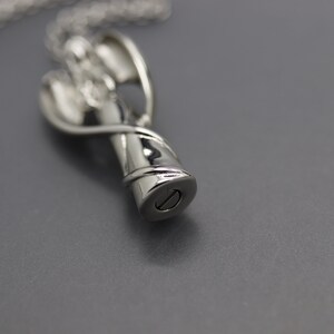 a silver necklace with a lighter on it