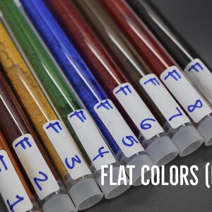 A collection of test tubes containing various colored liquids, each labeled with a number, arranged in a row.