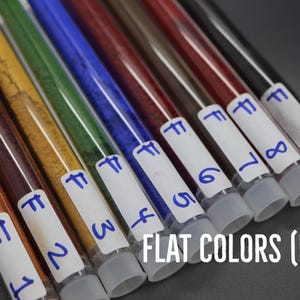A collection of test tubes containing various colored liquids, each labeled with a number, arranged in a row.
