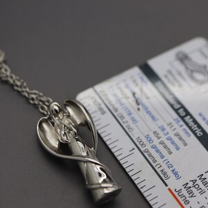 a close up of a metal object on a chain