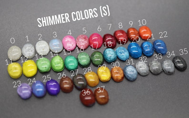A collection of colorful gemstones or stones, each with a unique color, arranged in rows and columns. The stones are labeled with numbers, likely representing their colors or shades.
