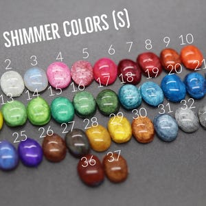 A collection of colorful gemstones or stones, each with a unique color, arranged in rows and columns. The stones are labeled with numbers, likely representing their colors or shades.