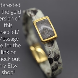 a gold ring with a message written below it