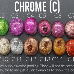 a collection of colorful glass beads or stones, each with a different color and texture, arranged in a grid pattern.