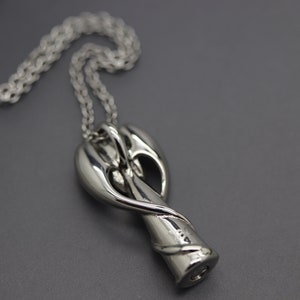 a close up of a necklace on a chain