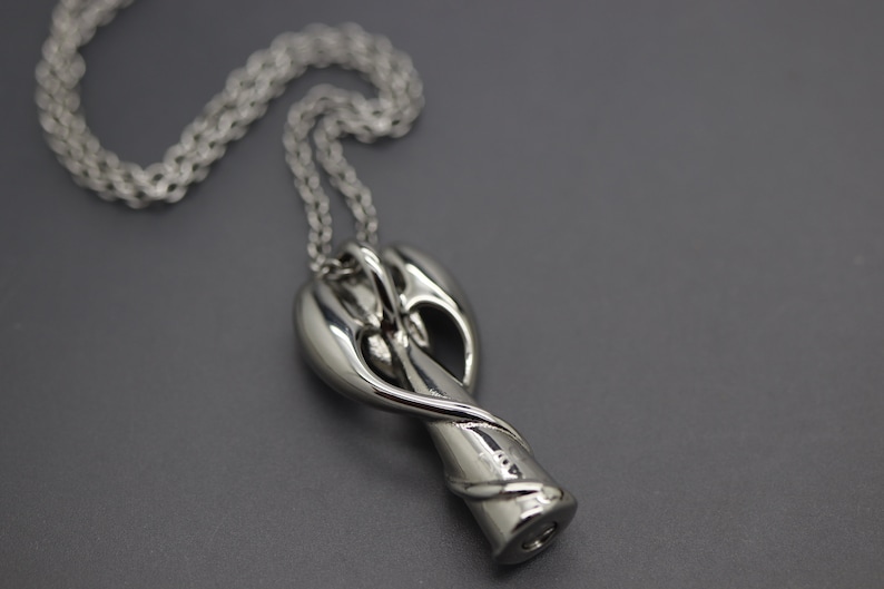 a close up of a necklace on a chain