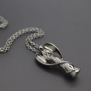 a silver necklace on a black surface