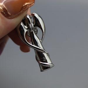 a close up of a person holding a metal object