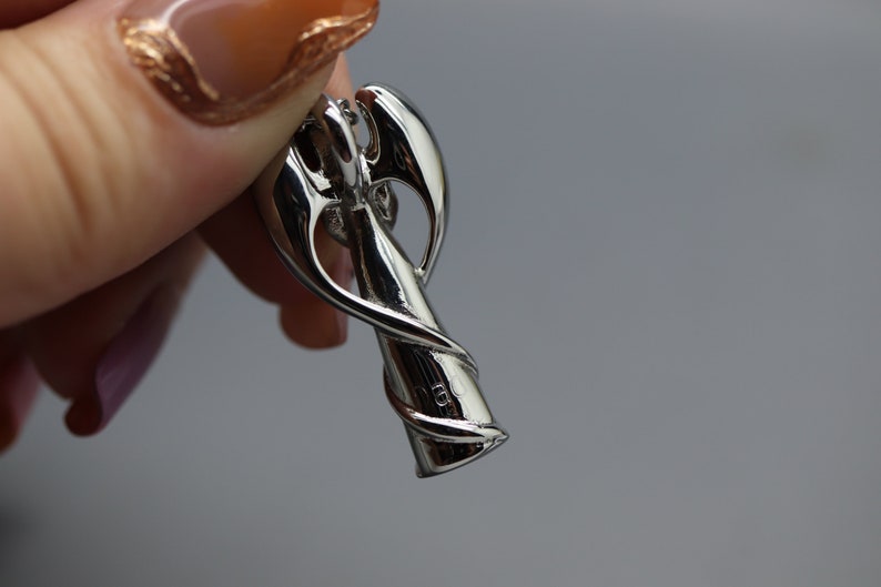 a close up of a person holding a metal object