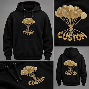 Puede incluir: Una sudadera negra con capucha que presenta un diseño bordado de un grupo de globos dorados. Los hilos de los globos se extienden hacia abajo para formar la palabra CUSTOM en hilo dorado. La sudadera incluye un bolsillo frontal y cordones.
