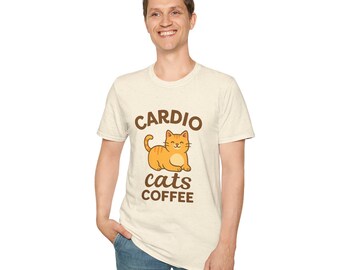 May include: A light beige t-shirt with the words "CARDIO cats COFFEE" in brown lettering. A cartoon orange cat is in the center. The person is wearing blue jeans.