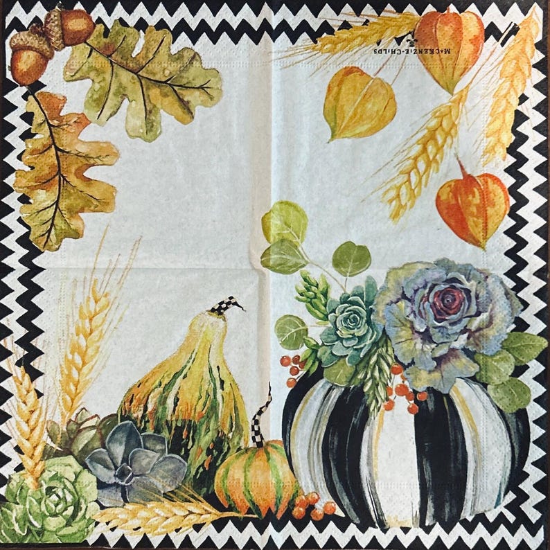 May include: A square paper napkin featuring a black and white chevron border. The design includes watercolor illustrations of acorns, oak leaves, wheat stalks, orange physalis, succulents, and pumpkins, one with black and white stripes.