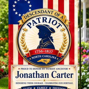 May include: A rectangular garden flag featuring a red, white, and blue American flag background with a circular emblem. The emblem shows a silhouette of a patriot, the text "DESCENDANT OF A PATRIOT", "1756-1837", "NORTH CAROLINA", and "NC". Below, the text "Jonathan Carter" is displayed with "PROUD TO HONOR MY PATRIOT ANCESTOR", "HONORING THEIR COURAGE. CELEBRATING OUR HERITAGE.", "FAITH FAMILY FREEDOM", and "AMERICA 1776" with an eagle graphic.