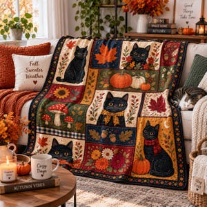 May include: A rectangular throw blanket featuring a patchwork design with illustrations of black cats, orange pumpkins, red maple leaves, sunflowers, mushrooms, and acorns. The pattern includes various autumn-themed motifs in shades of orange, red, yellow, and brown, bordered by a dark blue and gold decorative trim.