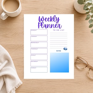 May include: A white weekly planner sheet with purple text reading Weekly Planner, featuring seven labeled boxes for days of the week, a lined to-do list section, a notes section with a blue gradient, and a small blue floral graphic illustration.