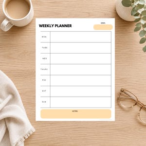 May include: A white weekly planner sheet with black text and horizontal lines for each day of the week from Monday to Sunday. The header reads WEEKLY PLANNER with a light orange box for the week, and a large light orange box at the bottom for notes.