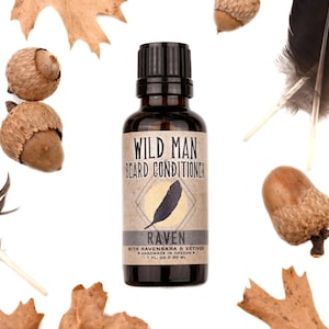 Wild Man Beard Oil Conditioner - Raven scent in 30ml amber glass bottle.Black feathers, acorns and dried oak leaves surround.