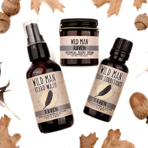 Wild Man beard care set in Raven scent with 30ml Beard Conditioner, 2oz Beard Wash and 1oz Beard Cream. Black feathers, acorns and dried oak leaves surround.