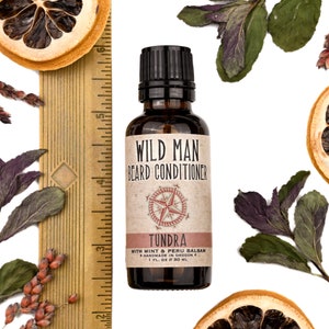 Wild Man Beard Oil Conditioner Tundra scent in 30ml amber glass bottle. Show with ruler at about 3.75" tall.  Lemon slices and peppermint leaves surround.