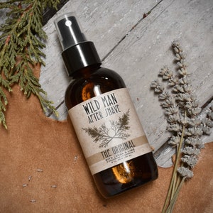 WIld Man After Shave 4oz amber glass bottle in The Original scent. Dried botanicals surround.