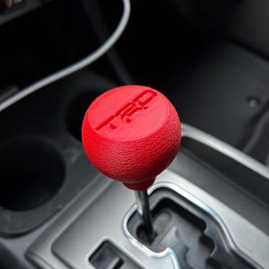 May include: A trio of ceramic mugs with a speckled, matte finish in cream, light grey, and dark grey. Each mug features a minimalist design and a rounded handle. Suitable for tea or coffee, these mugs offer a simple, modern aesthetic.