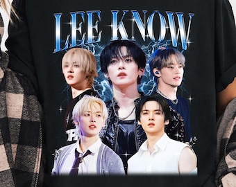 May include: Black t-shirt with the text "LEE KNOW" in blue and white, and images of five people. The shirt has a crew neck and short sleeves. The design is likely related to music or pop culture.