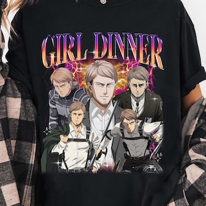 May include: A black t-shirt featuring a graphic print with the text GIRL DINNER in a gradient font. The design includes five illustrations of the same anime character in various outfits and poses, set against a background of purple lightning.