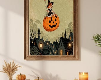 May include: A framed Halloween-themed print depicts a young witch riding a jack-o'-lantern balloon over a town. The artwork features a vintage style with a warm color palette, including orange, black, and green. The print is displayed on a wooden cabinet with decorative pumpkins and a lit candle.
